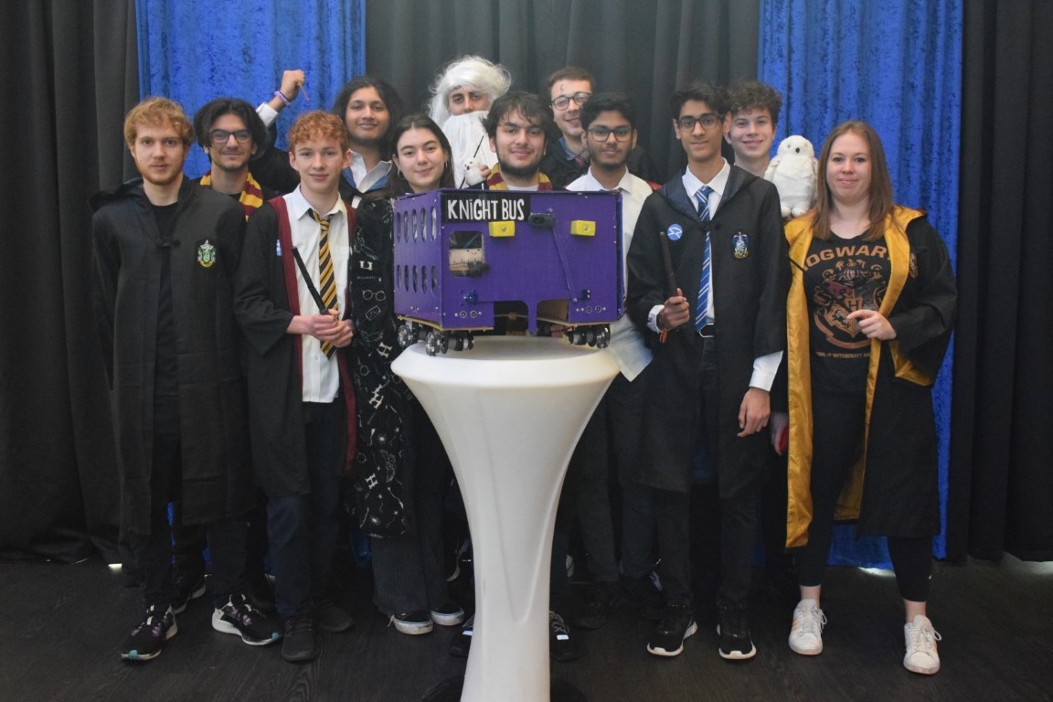 The
           competitors from Haberdashers' School standing with their robot